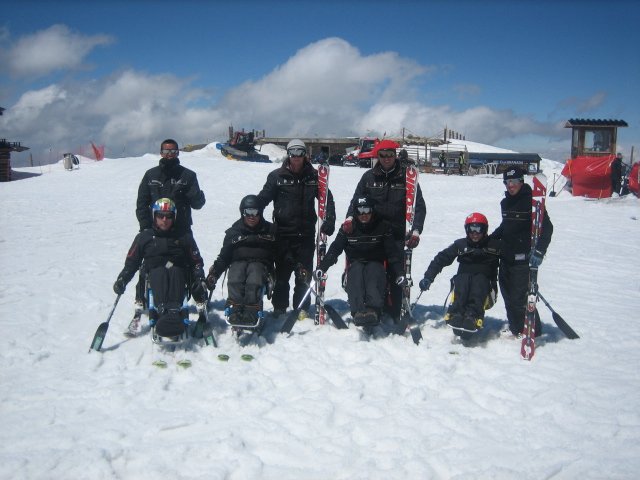 Fotografía de grupo de esquiadores y monitores
